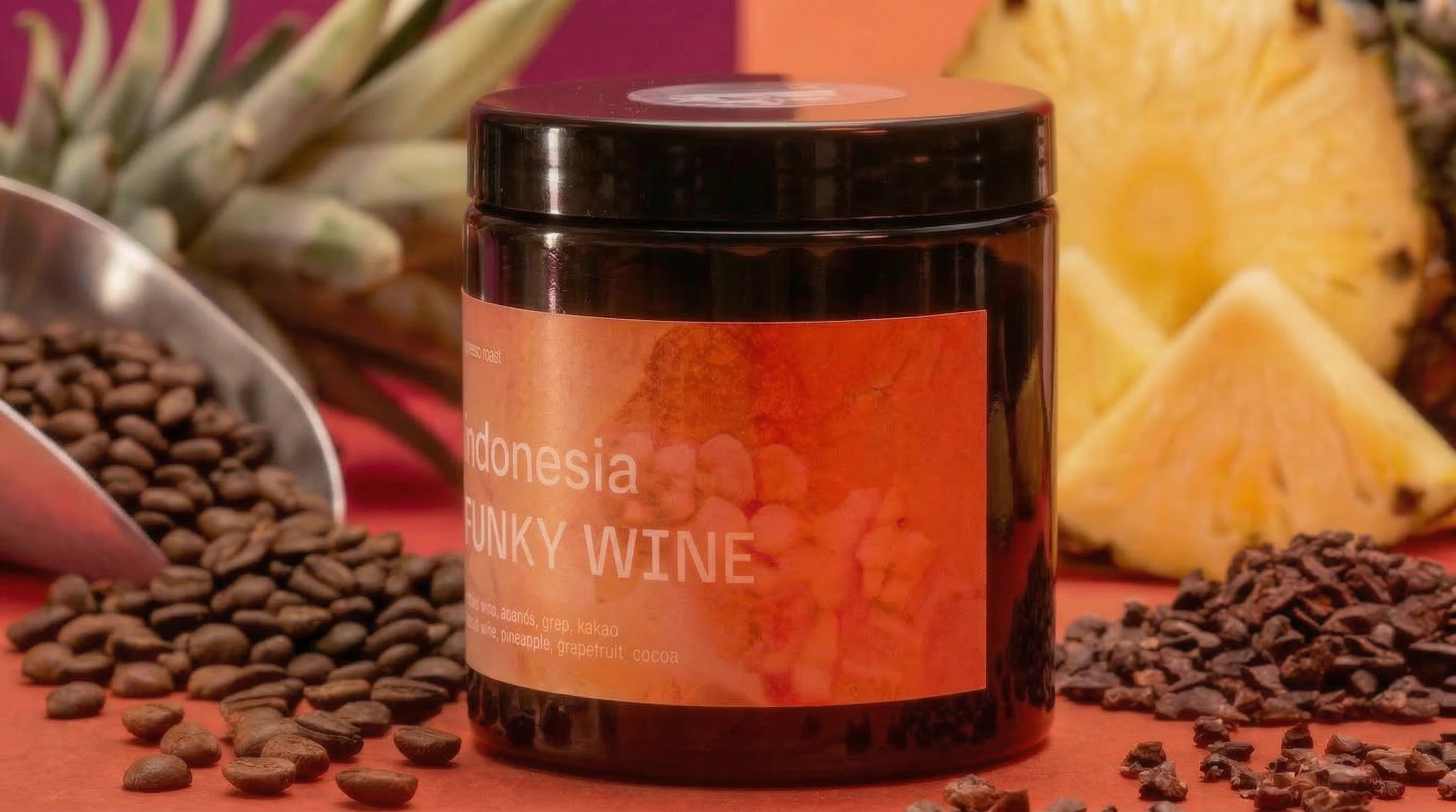 Funky Wine jar with scattered coffee beans and cocoa nibs on coral background