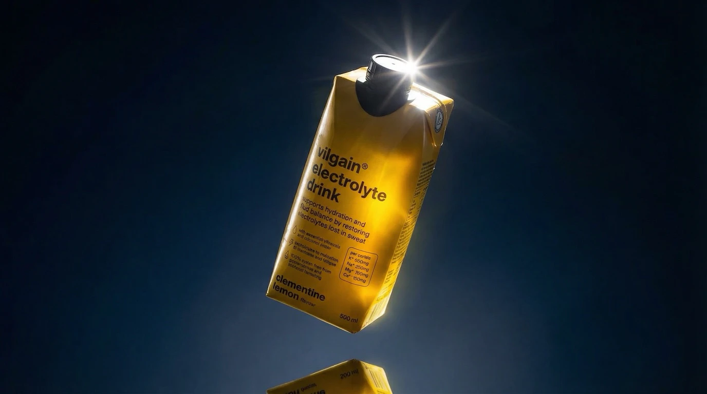 Electrolyte drink with starburst flare against dark blue